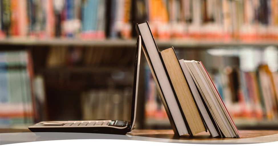Laptop and books on a table