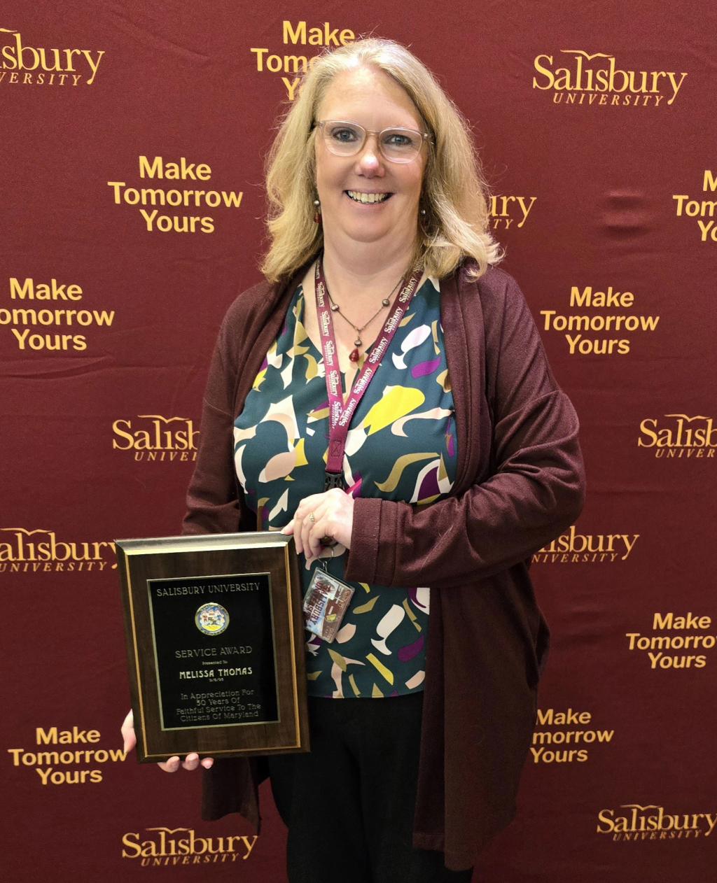 Melissa Thomas holds her 30 Years of Service plaque.