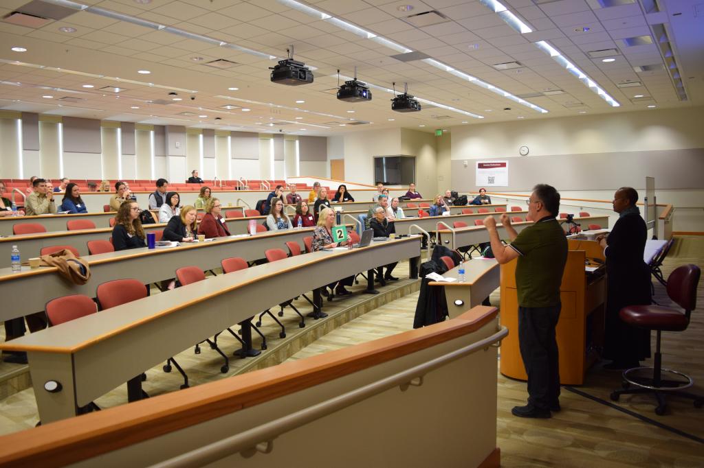 staff & faculty attend a conference in an auditorium classroom during a Teaching and Learning conference