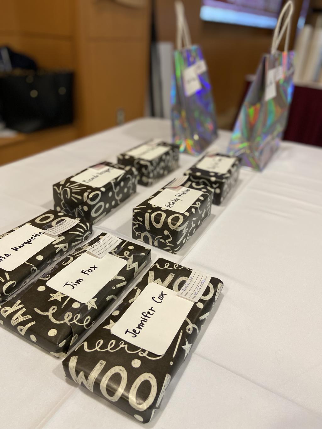 Teaching & Learning Conference prizes arranged on a table with the winners names attached to them.