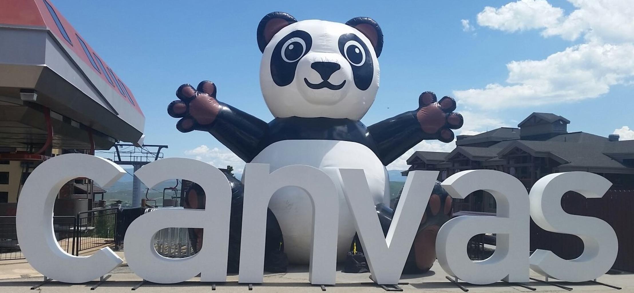 Outdoor Canvas display with large inflatable panda mascot