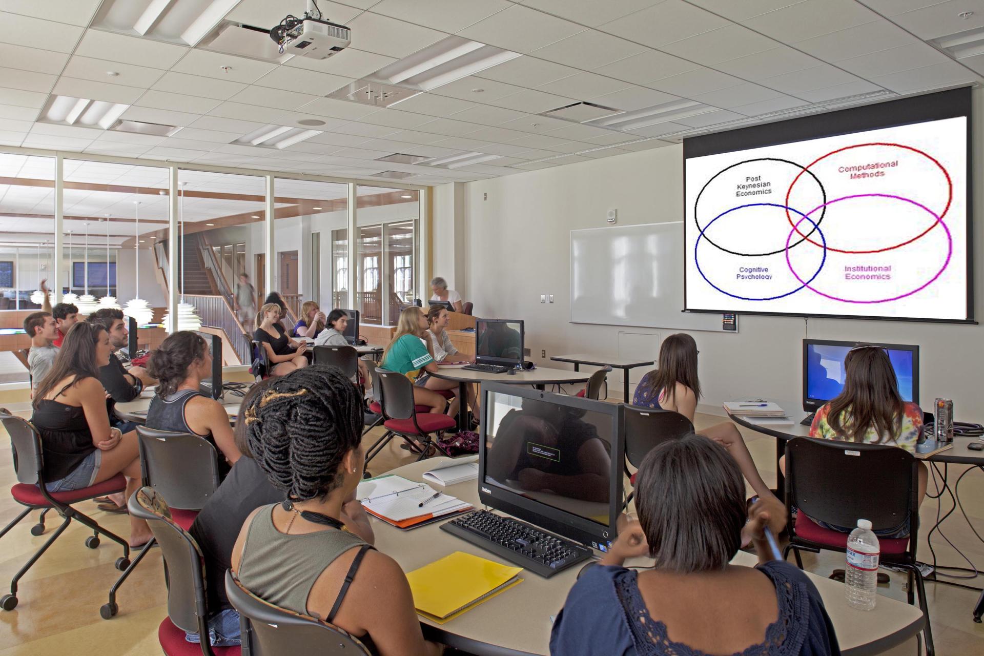 Students in a Perdue Hall classroom looking at a PowerPoint presented by an instructor.