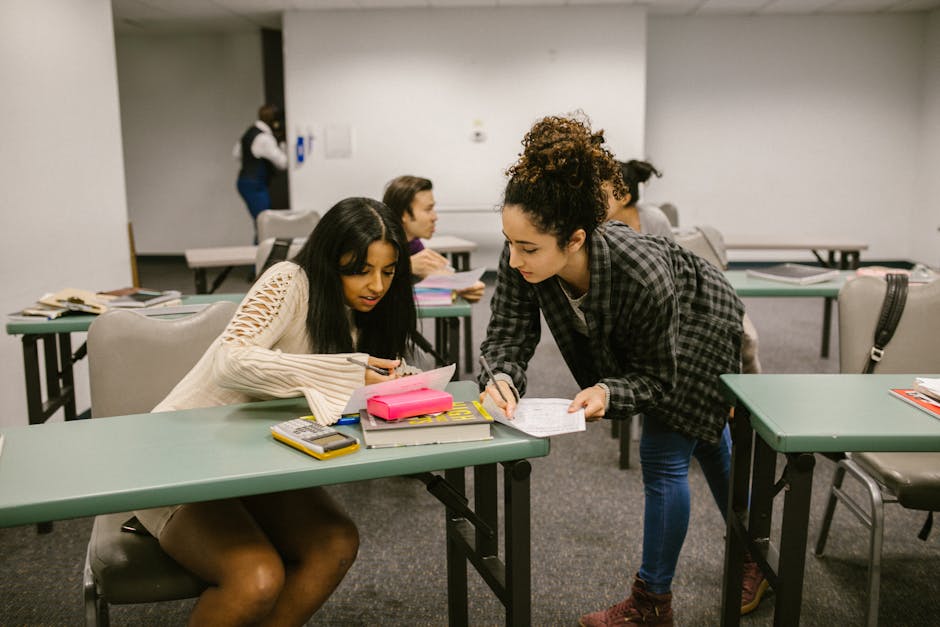 Classroom with three students and a teacher in conversations