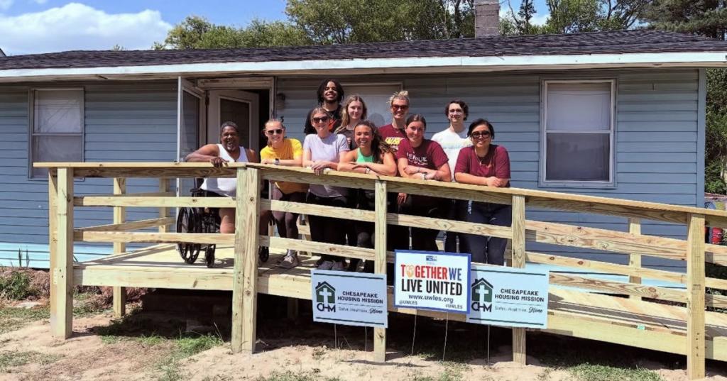 Beta Alpha Psi and Beta Gamma Sigma posing on a newly built ramp